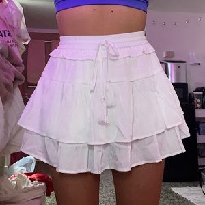 Flowy white skirt with adjustable waistband and shorts underneath.